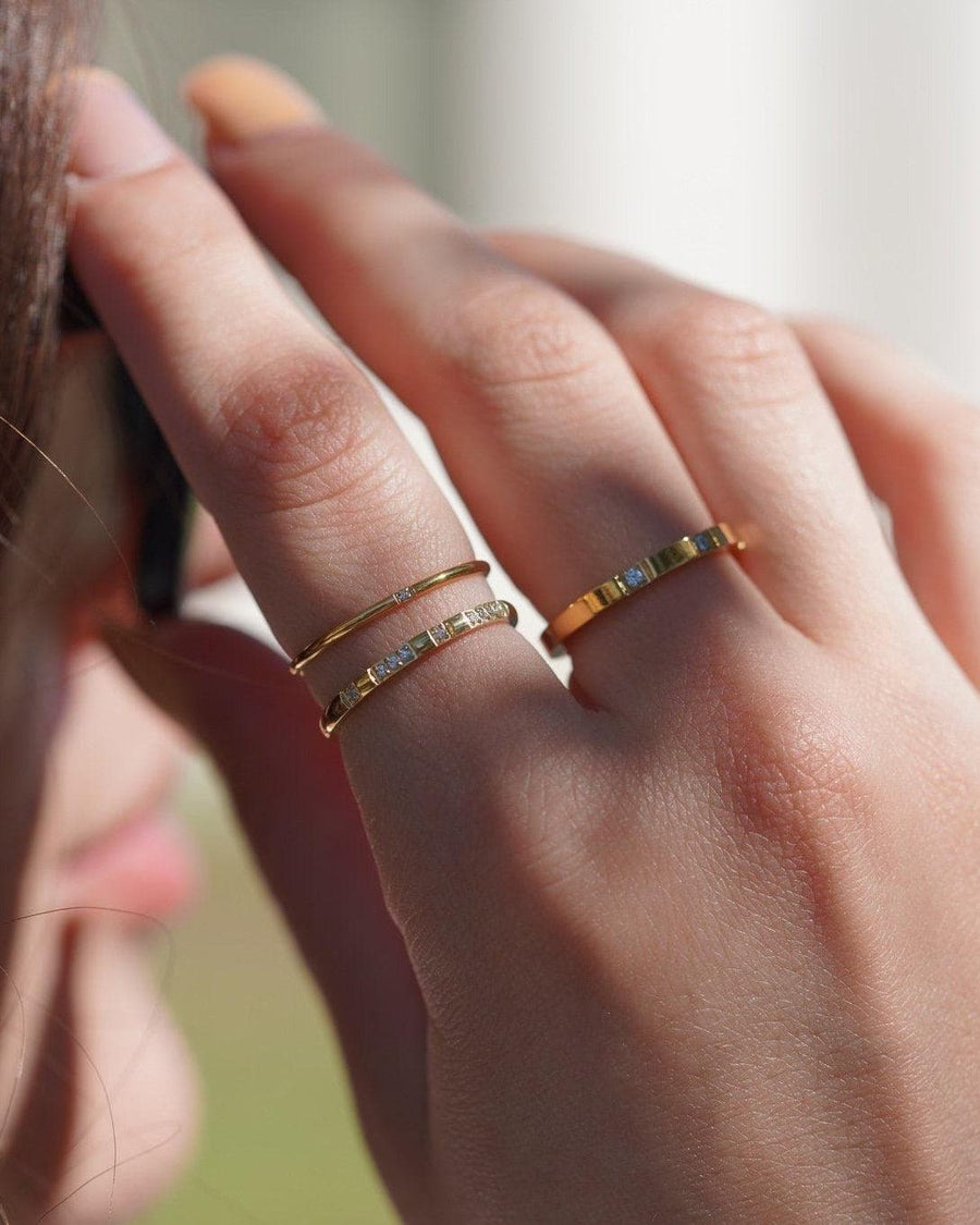 Model Image - Octo Stackable Ring worn with slim gold plated stainless steel rings and sparkling stones on hand