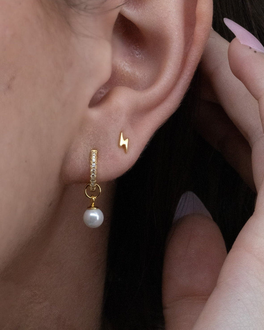 Model Image - Lightning bolt stud earring styled on the earlobe with a second drop earring worn on model