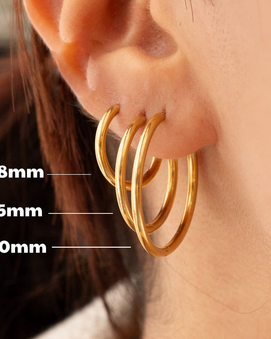 Model Image - Gold plated hoop earrings shown in 18mm, 25mm, and 30mm sizes worn on model