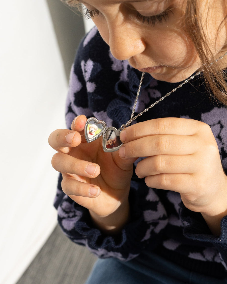 Detail Image - Open heart locket necklace with photo personalization held in hand.