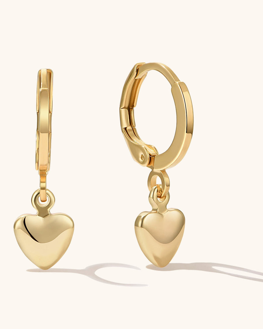 Main Image - 14k gold plated hoop earrings with dangling puffy heart pendants on a neutral background