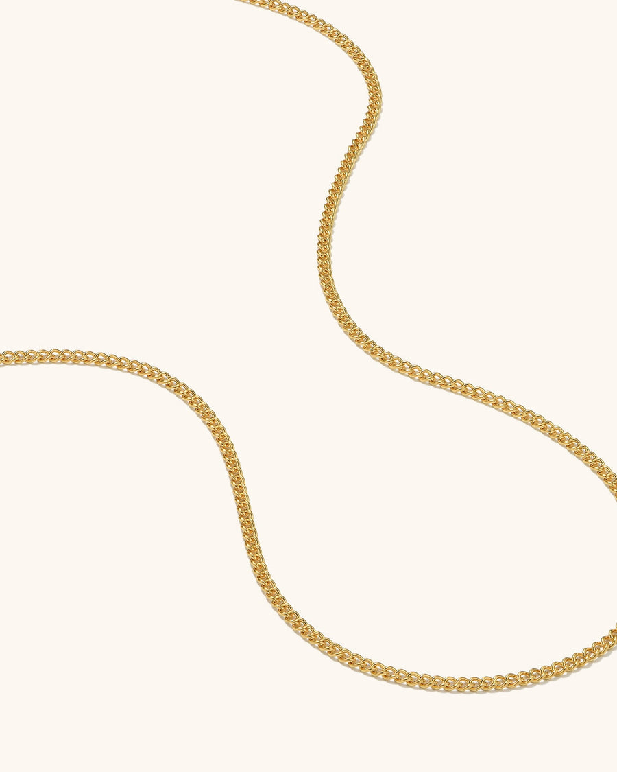  slim 14K gold baby curb chain necklace with a clean minimal profile worn on model