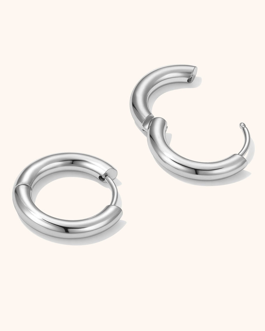 Simple 10mm silver hoop earrings worn on model