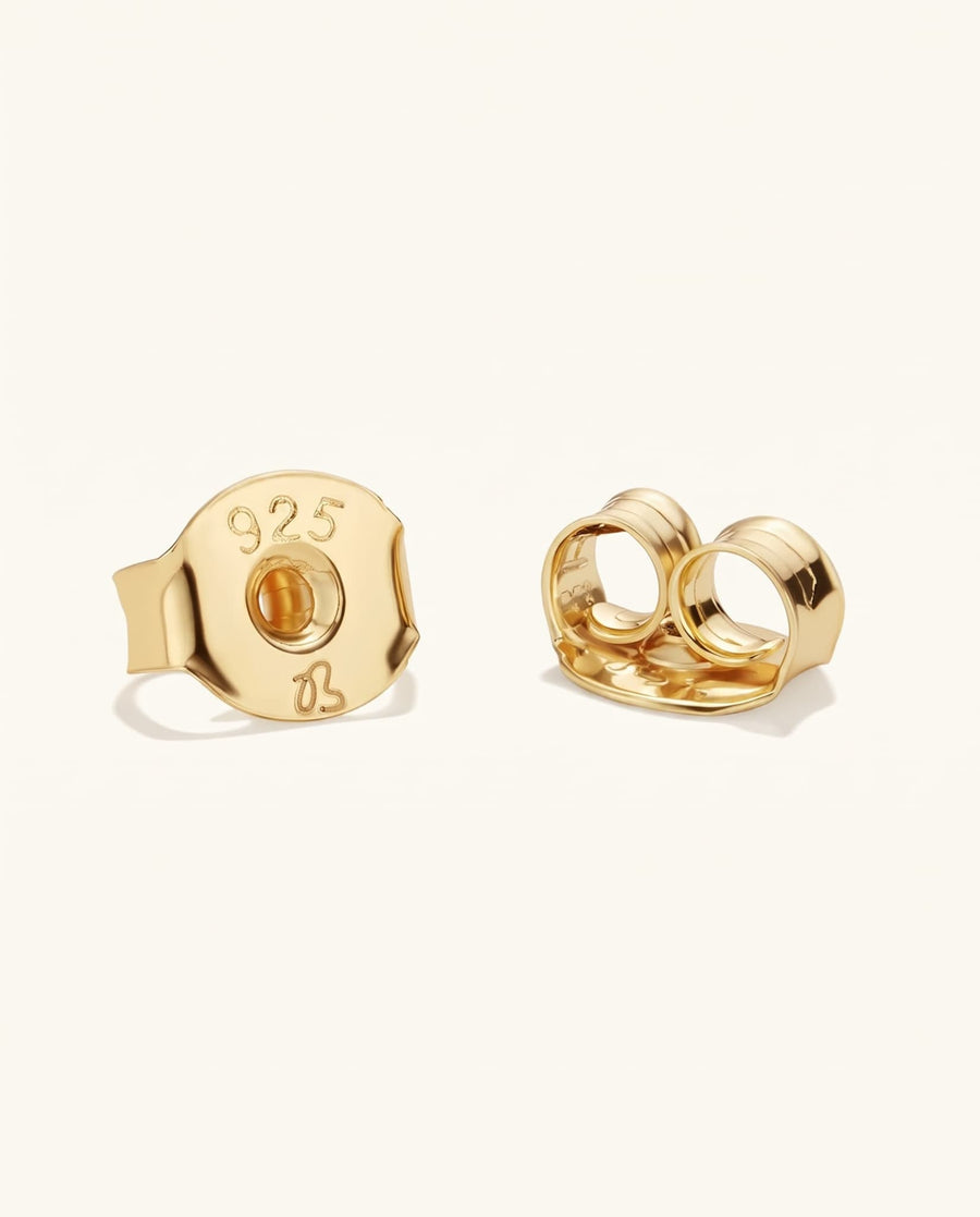 Detail Image - Close-up of gold earring backs for the Paved Cross Studs, showing butterfly clutch closures.