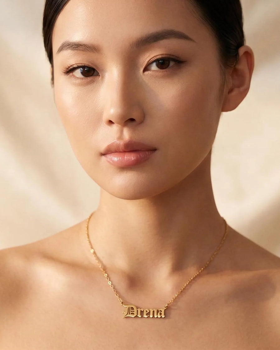 Model Image - 14K gold Old English name necklace with a personalized name pendant on a delicate chain worn on model