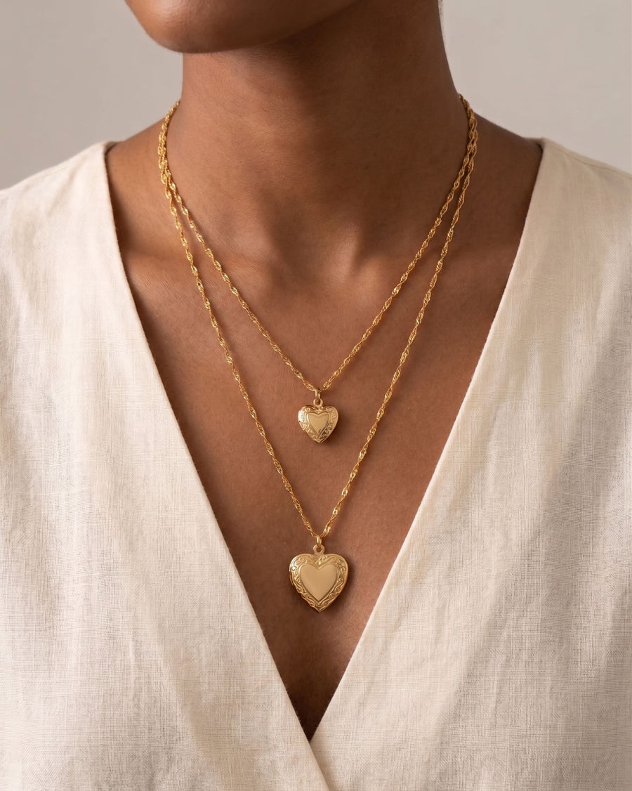 Model Image - layered 18k gold heart locket necklaces with engraved-style border details worn on model