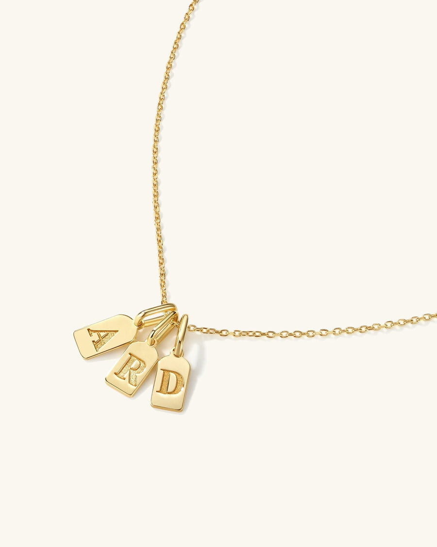 Detail Image - 14K gold initial tag charms with engraved A, B, and D letters on a delicate chain