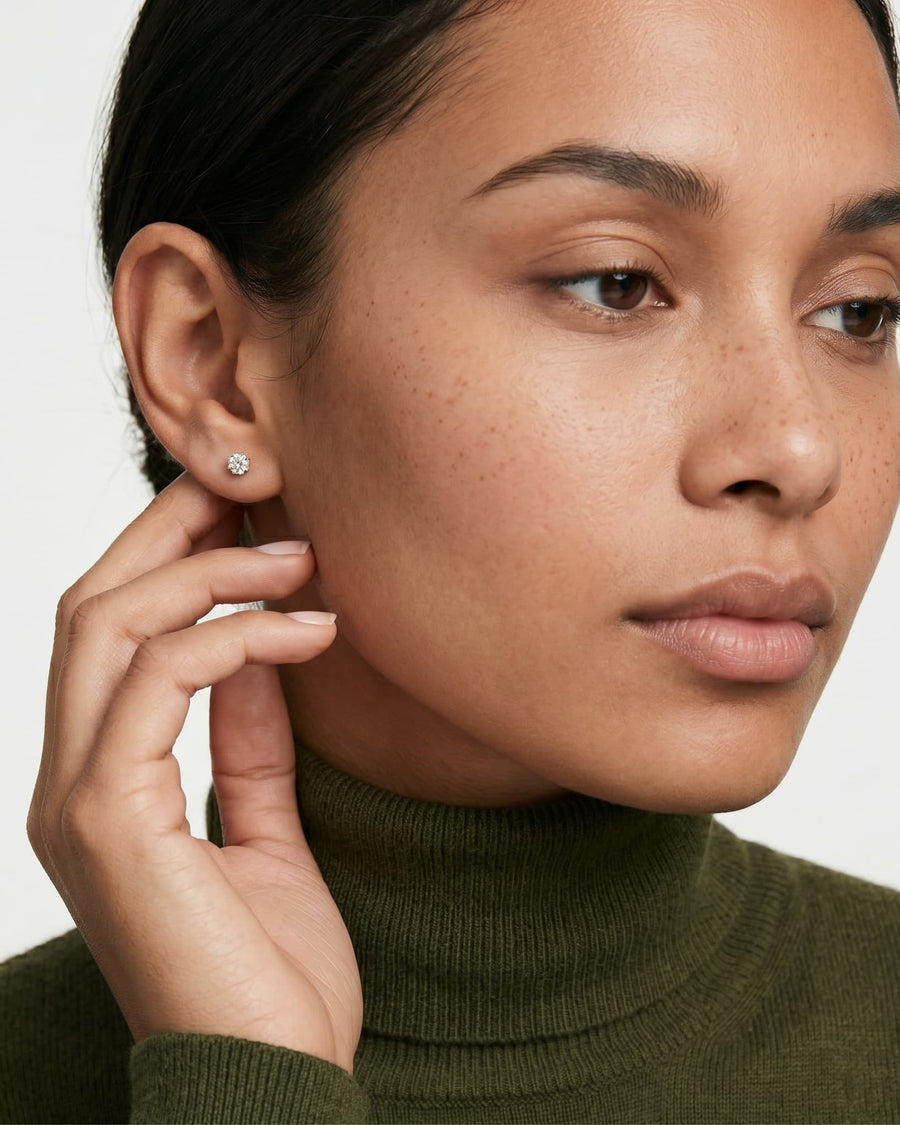 Model Image - round lab-grown diamond stud earring in a sleek bezel setting worn on model