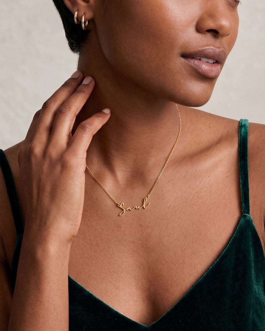 Model Image - 14K Gold personalized name necklace with script pendant resting at the collarbone worn on model