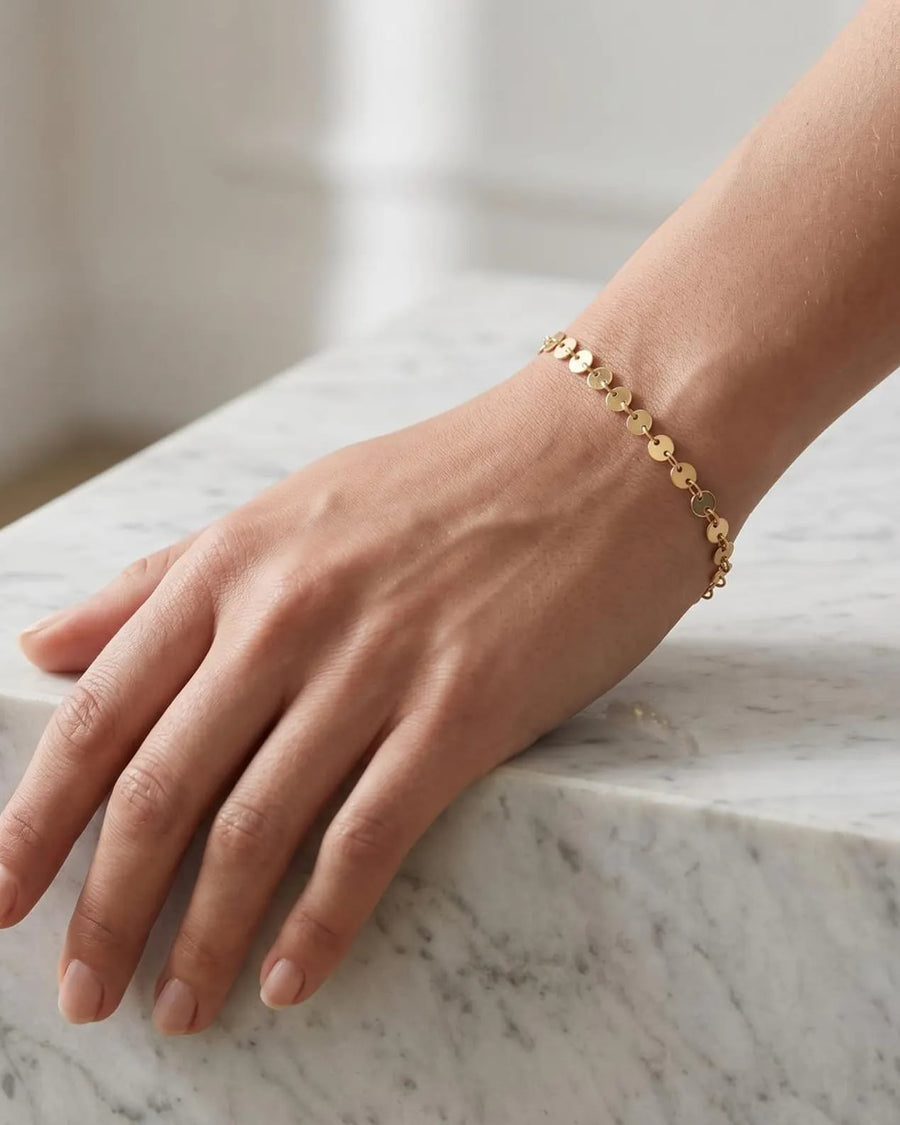Model Image - Gold disc chain bracelet worn on wrist with textured disc links